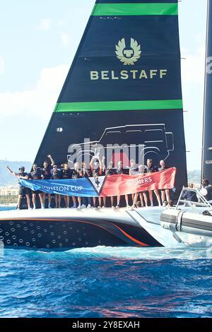 2024 America's Cup - Barcelona, Spain Final Round Robin LVC race 11: Britannia, the banner of the winner of the Cup on the bow of Britannia and Sir Ben Ainslie with the Louis Vuitton Cup in the hand.  PHOTO CREDIT: © Alexander Panzeri/PPL Stock Photo