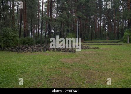 Riga, Lithuania - Sep 13, 2024: Holocaust memorial in Rumbula forest. Here 26,000 people, most of them Jews, were executed during World War II. Cloudy Stock Photo