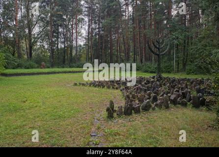 Riga, Lithuania - Sep 13, 2024: Holocaust memorial in Rumbula forest. Here 26,000 people, most of them Jews, were executed during World War II. Cloudy Stock Photo