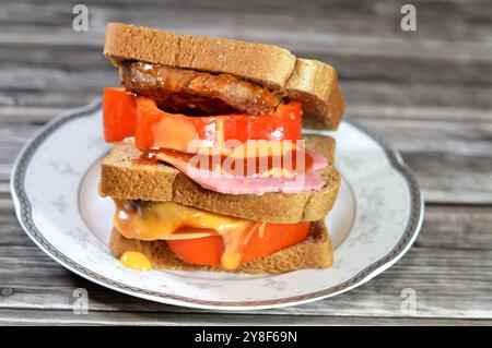 multilayer whole wheat brown toast filled with fried beef burger cooked in a boiling shallow oil with slices of colored bell peppers and Lunch meats, Stock Photo