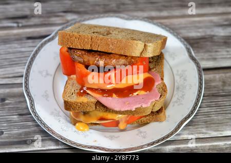 multilayer whole wheat brown toast filled with fried beef burger cooked in a boiling shallow oil with slices of colored bell peppers and Lunch meats, Stock Photo