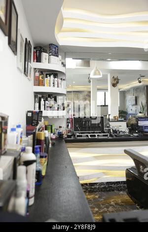 Barbershop countertop with various grooming products, tools, and equipment neatly organized. Stock Photo