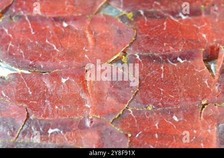 Thin slices of beef pastrami, made from beef brisket, raw meat is brined, partially dried, seasoned with herbs and spices, then smoked and steamed, li Stock Photo