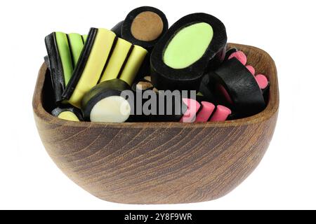 Finnish mixed licorice candies in a wooden bowl isolated on white background Stock Photo