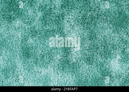 Faux fur, velours turquoise fabric or cloth. Fluffy fabric texture of artificial fur textile material. Canvas background. Decorative fabric for curtai Stock Photo