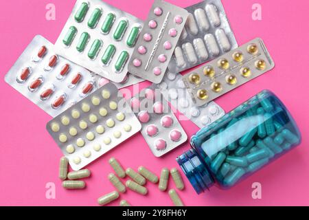 Pharmacist concept. Flat lay composition with many different pills on pink background Stock Photo