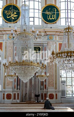 Turkiye. Istanbul. A muslim man prays inside the Ortakoy mosque Stock Photo