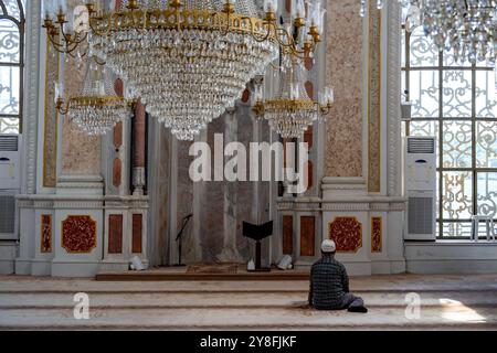 Turkiye. Istanbul. A muslim man prays inside the Ortakoy mosque Stock Photo