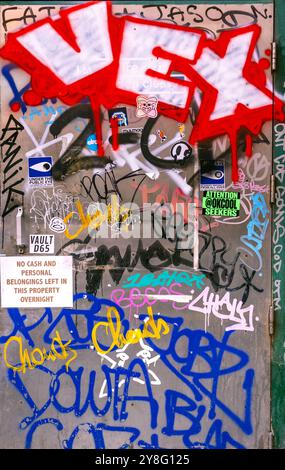 Colorful graffiti scrawled on a metal door creates a background with an interesting texture suitable for an urban concept Stock Photo