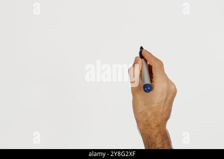 A man writing with blue color marker isolated on white. Space for text. Stock Photo