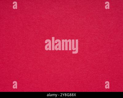 The image showcases a rich red textured paper surface, exuding warmth with its vibrant and inviting tone Stock Photo