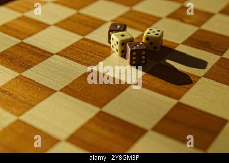 Stack of dices on brown wooden board background Stock Photo