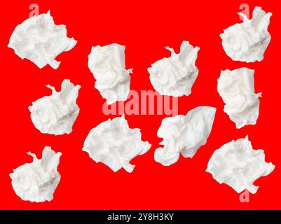 Top view set of screwed or crumpled white tissue paper ball is isolated on red background with clipping path. Stock Photo