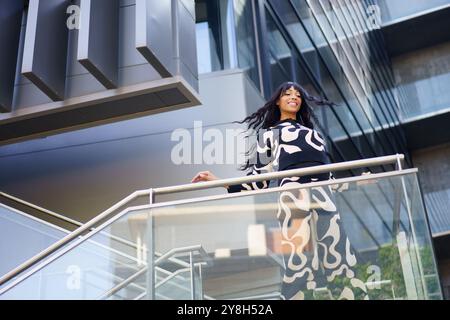 Dancer performing from urban stairs on a financial building Stock Photo