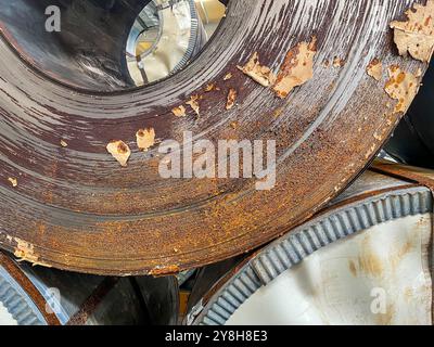 Rolls of rusty steel sheet inside the factory or warehouse. Problem on the surface of metal or iron. Stock Photo