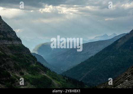 Subtle Rays Through Clouds Over Logan Pass in Glacier Stock Photo