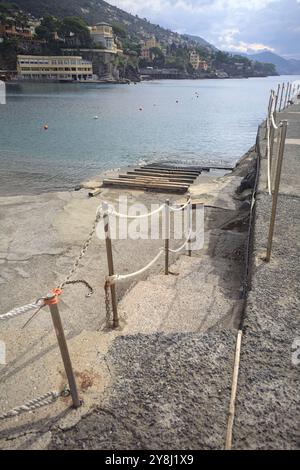 Towage lane in a pier next to a beach in an italian town on a cloudy day Stock Photo