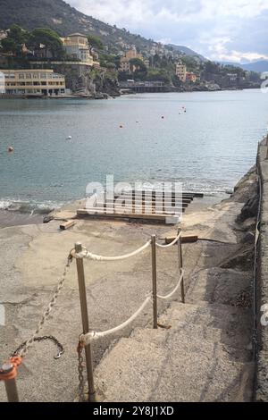 Towage lane in a pier next to a beach in an italian town on a cloudy day Stock Photo