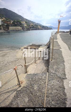 Towage lane in a pier next to a beach in an italian town on a cloudy day Stock Photo