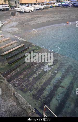 Towage lane in a pier next to a beach in an italian town on a cloudy day Stock Photo