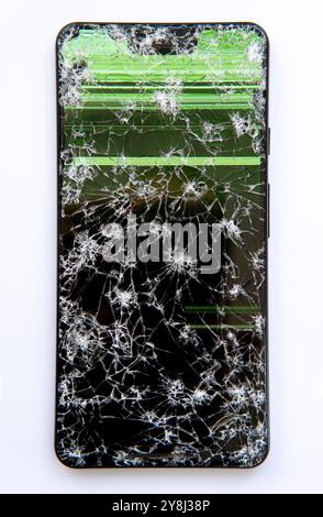 Smartphone with broken screen showing crack lines on the glass in close up view Stock Photo