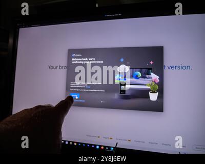 Paris, France - Apr 3, 2024: User syncing settings on Microsoft Edge across multiple devices, enabling data like favorites, passwords, and history to follow seamlessly between computer and mobile - updates Stock Photo