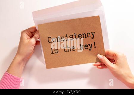 Inspirational Quote - Consistency is the key text written on paper background. Stock photo. Stock Photo