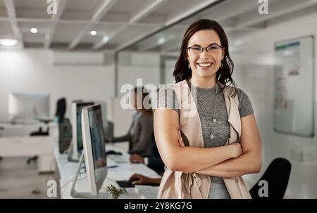 Portrait, happy woman and manager with arms crossed in office for business experience. Face, confident leader or pride of expert product designer with Stock Photo