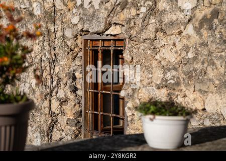The wall of an old building is bathed in warm light by the first rays of sunlight. Stock Photo