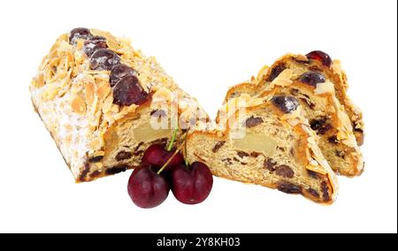 Cherry and almond stollen fruit cake filled with raisins and marzipan and decorated with glace cherries and flaked almond isolated on a white background Stock Photo