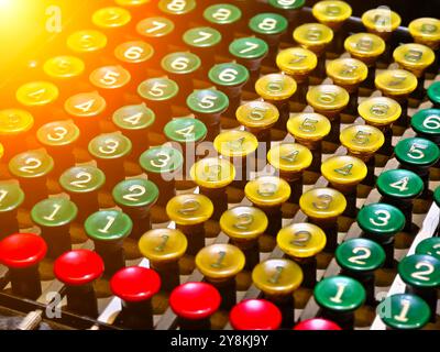 An old fashioned adding machine features a drawer located underneath it Stock Photo