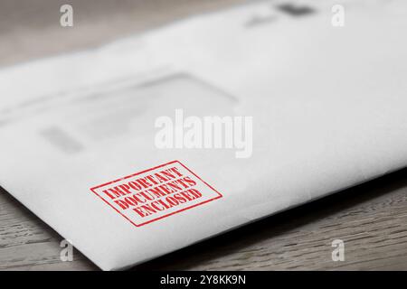 Important documents enclosed letter stamped in red on an envelope. Official business paperwork mail concept Stock Photo