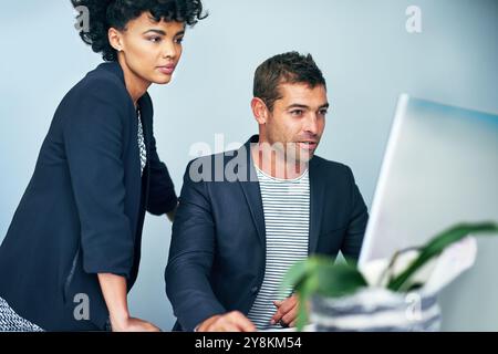 Business, people and serious on computer at office for digital files or data as administrators. Employees, meeting and confident with coworking as com Stock Photo