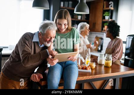 Portrait of happy multigeneration, multiethnic family having fun in kitchen at home Stock Photo