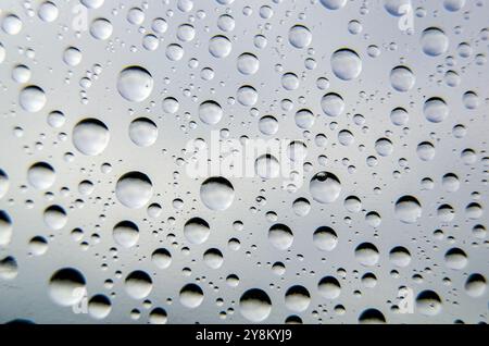 Top view of rainwater droplets on clear plastic. Fresh rain concept. Stock Photo