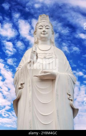 Big white statue of Lady Buddha in Da Nang in Vietnam on the Linh Ung pagoda on the background of the blue sky Stock Photo