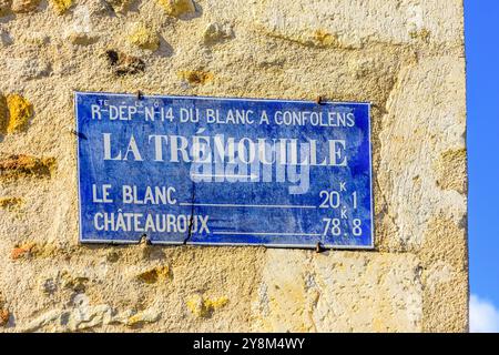Old ceramic road sign with direction from "La Trémouille" on wall of house - La Trimouille, Vienne (86), France. Stock Photo