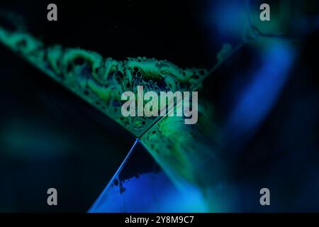 Bright reflection of liquid in macro, blue and silver colors, rainbow background, Blue bubbles in macro, connection of bubbles in macro Stock Photo