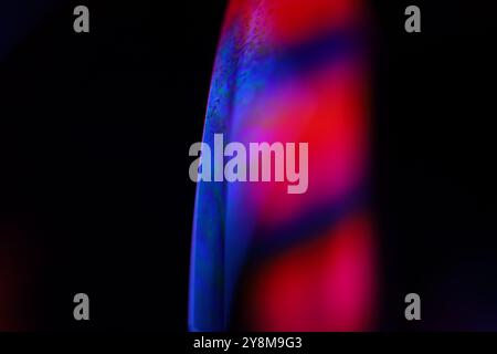 Red and purple fluid pattern, fluid background, plasma, fluid movement, red sphere, dark gloomy background, smooth moving, one line in the dark Stock Photo