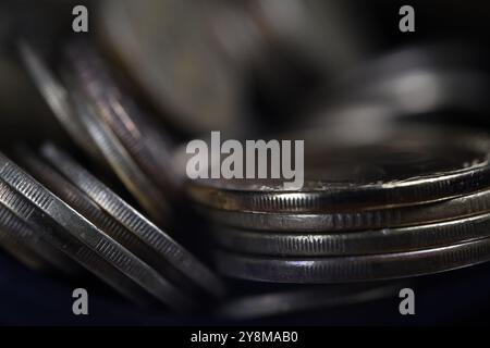 A pile of coins on a dark background, brown coins in close-up, texture of old coins, dark background, light movement, Ukrainian coins Stock Photo
