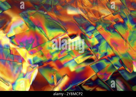 Crystals of Erbium Nitrate under a microscope. The crystals are precipitated from a solution on a microscope slide and photographed in polarized light Stock Photo