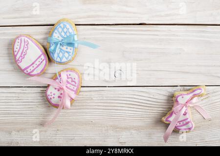 Easter frosted cookies in shape of egg and rabbit on white wooden table background flat lay horizontal mockup with copy-space Stock Photo