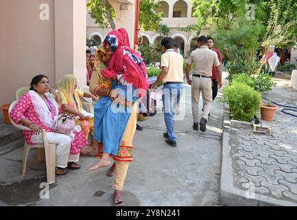 GURUGRAM, INDIA - OCTOBER 5: Pooja carrying to lap her 92-year-old mother-in-law to cast their vote for Haryana Assembly Election at Shiv public senior secondary school at Sohna, on October 5, 2024 in Gurugram, India. A total of 1,031 candidates are contesting in all 90 assembly constituencies, and 20,632 polling booths have been set up for voting. A total of 2, 03, 54,350 voters in the state will be able to exercise their rights in the 15th Haryana Legislative Assembly Elections. (Photo by Parveen Kumar/Hindustan Times/Sipa USA ) Stock Photo