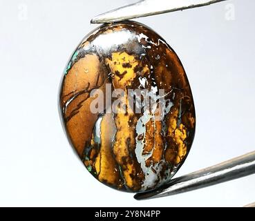 Stunning Natural Tiger Eye Gemstone with Rich Golden and Brown Striations. Stock Photo