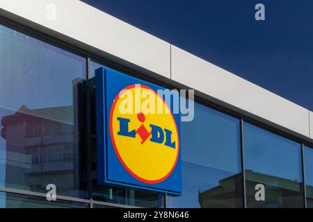 The exterior of a lidl supermarket with a large logo sign on a sunny day in leiria, portugal Stock Photo