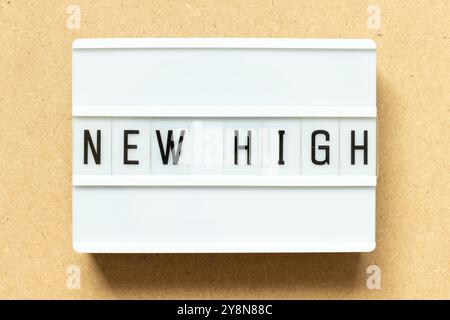 Lightbox with word new high on wood background Stock Photo