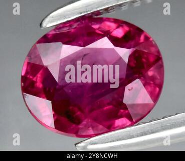 Stunning and Radiant Natural Ruby Gemstone in an Elegant Oval Cut Setting. Stock Photo