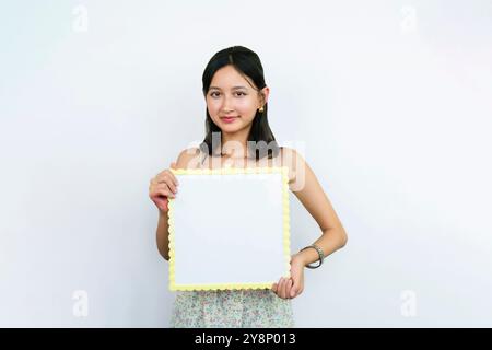 Young Asian Tutor Teacher with a white board teaching. Blank white board for English Language Stock Photo