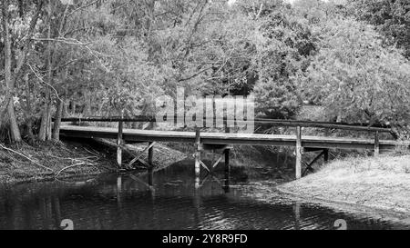 Bridge to Island over part of a lake Stock Photo