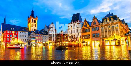 Trier, Germany: Sunset view of the Hauptmarkt, the Main Market. Medieval center of Trier surrounded by historic buildings and St. Gangolf church Stock Photo